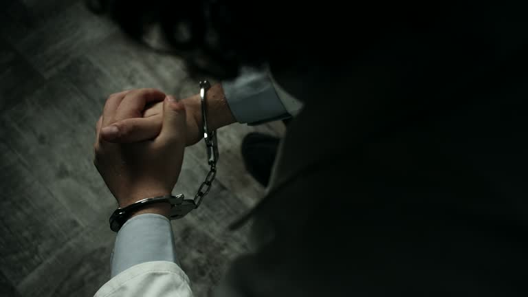 Close-up, doctor at prison cell